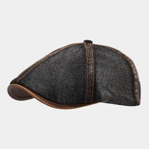 Detailed side view of washed black denim flat cap with contrast stitching and leather trim