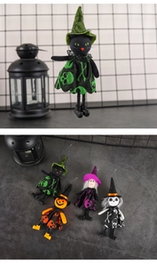 Detail of Halloween felt hanging plush dolls featuring black cat, witch, and pumpkin characters