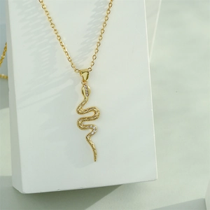18K gold plated snake pendant necklace with shimmering cubic zirconia on display stand