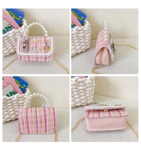 Detail view of pink tweed girls handbag with pearl handle and floral bunny charms