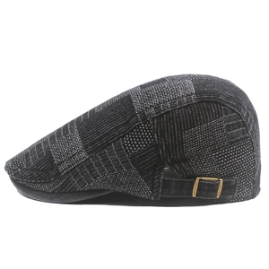 Close-up of vintage plaid flat cap with bronze adjustable metal buckle on the side