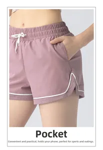 Detail view of mauve running shorts with a functional side pocket and layered design