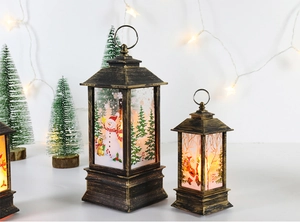 Set of two vintage bronze Christmas lanterns with warm LED light and Santa motifs