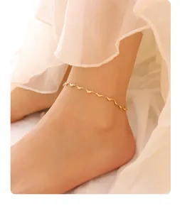Détail d'une chevillère en acier inoxydable plaqué or 18K avec breloques en forme de feuilles