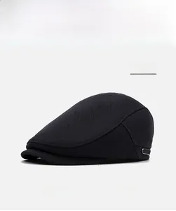 Detail of a black ivy cap featuring a breathable mesh texture and metal buckle accent