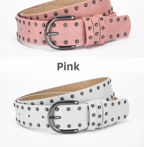 Detail of pink and white punk belts featuring three rows of round metal rivets and buckles