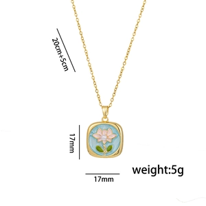 Gold chain necklace with a light blue enamel flower pendant and pink petal details