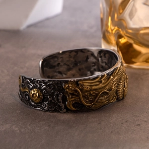 Macro detail of vintage dragon relief on a titanium steel cuff bracelet for men