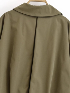 Detail view of the collar and back stitching on a military green bomber jacket for women