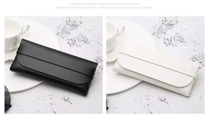 Minimalist leather glasses pouches in black and beige, shown in a cozy home setting