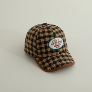 Detailed embroidery on a brown houndstooth checkered baseball cap for children