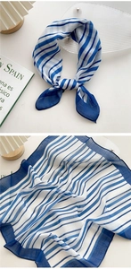 Detail of blue and white striped cotton linen neckerchief with soft knot styling