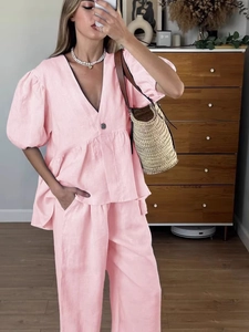 Pink linen two-piece set featuring V-neck puff sleeve top and wide-leg trousers