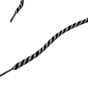 Macro detail of black and white spiral woven shoelaces with durable clear plastic aglets