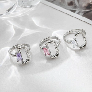 Close-up of three lava-textured rings with purple, pink, and clear rectangle stones