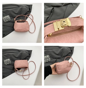 Detail view of pink strawberry themed shoulder bag with golden metal buckle clasp