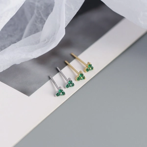 Detailed macro view of S925 sterling silver four-leaf clover stud earrings with green zircon
