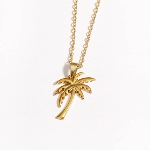 Detailed close-up of a gold coconut tree pendant on a matching metallic link chain