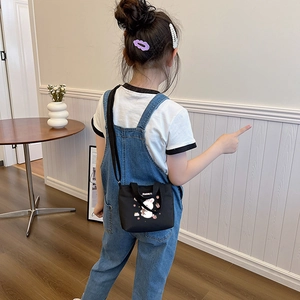 Kids black canvas crossbody bag with white rabbit print shown on a model