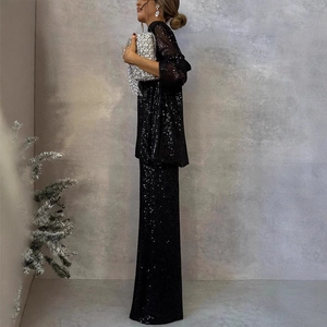Close-up of black sequin suit set with blazer and wide-leg pants on a fashion model