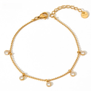 Detail of gold stainless steel anklet showing round zircon charms and secure lobster clasp