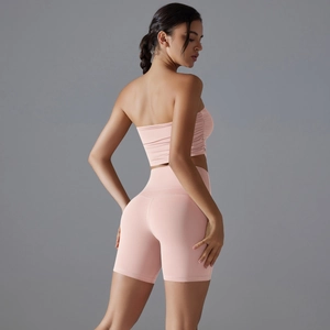 Detail view of the pink yoga set showing the seamless fabric texture and fitted back design