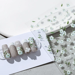 Autocollants ongles printemps avec marguerites blanches et feuilles sur base taupe