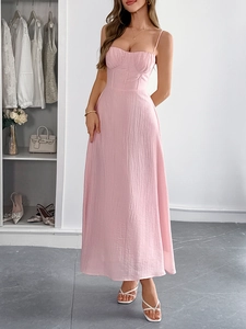 Detailed view of pink sleeveless maxi dress with pleated texture and bodice shaping