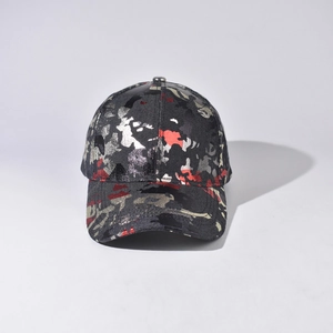 Detail of baseball cap featuring unique red and black camouflage pattern and curved brim