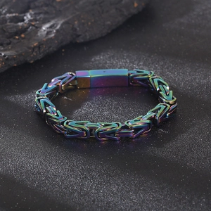 Close-up of rainbow gradient V-link Byzantine chain bracelet on dark stone texture