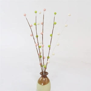 Artificial berry branches in pink, green, and cream white for spring home decoration