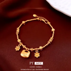 24K gold plated beaded flower bracelet with traditional Fu lock charm on silk background
