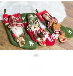 Detailed view of Christmas stockings with 3D Santa, Snowman and Reindeer plush designs