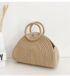 Detail shot of a beige woven tote bag with circular handles in a Nordic style setting