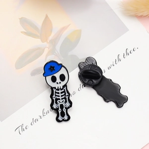 Skeleton officer enamel pin with blue cap shown from front and back on white card