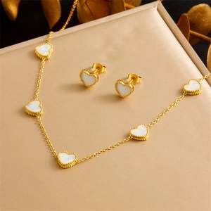 Elegant gold heart jewelry set including necklace and studs on velvet gift box