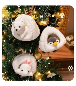 Christmas plush ornaments featuring a white bear, penguin, and seal in snowy nests on a tree