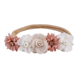 Detail of baby floral headband with handmade fabric flowers, pearls and rhinestones