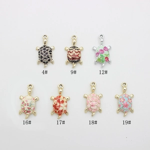 Detail of cartoon turtle charms with colorful enamel floral and leopard patterns