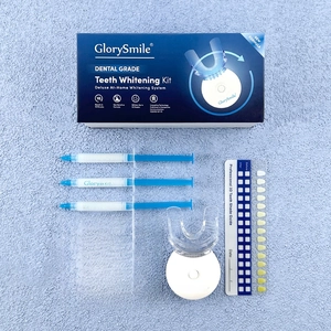 Complete professional teeth whitening kit with LED light, gels, and guide in blue and white