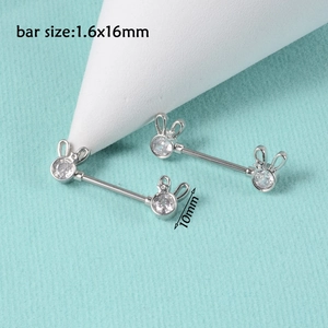 Detail of silver nipple bars with cubic zirconia rabbit designs, 1.6x16mm bar size
