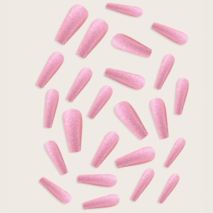 Detailed flat lay of pink glitter press-on nails set in various sizes on beige background