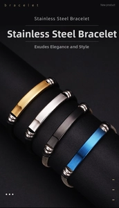Detail of four stainless steel bracelets in gold, silver, black, and blue with woven bands