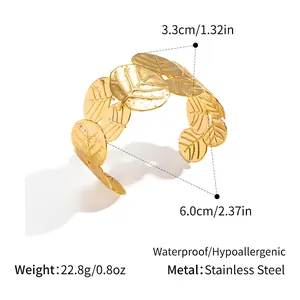 Macro detail of gold-plated stainless steel leaf bracelet showing vein texture and dimensions
