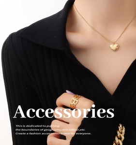 Close-up of heart pendant necklace and hollow B letter ring in 18K gold plated finish