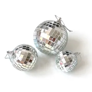 Three silver mirrored disco balls with hanging strings for party and event decoration