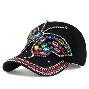 Distressed black baseball cap featuring a large colorful rhinestone butterfly and jeweled brim