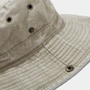 Detail of khaki canvas fishing hat with metal eyelets and reinforced stitching