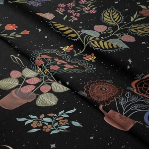 Close-up detail of Bohemian floral tapestry fabric showing texture, flowers, and stars
