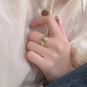 Close-up of gold-plated silver ring with square Dalmatian Jasper stone on model